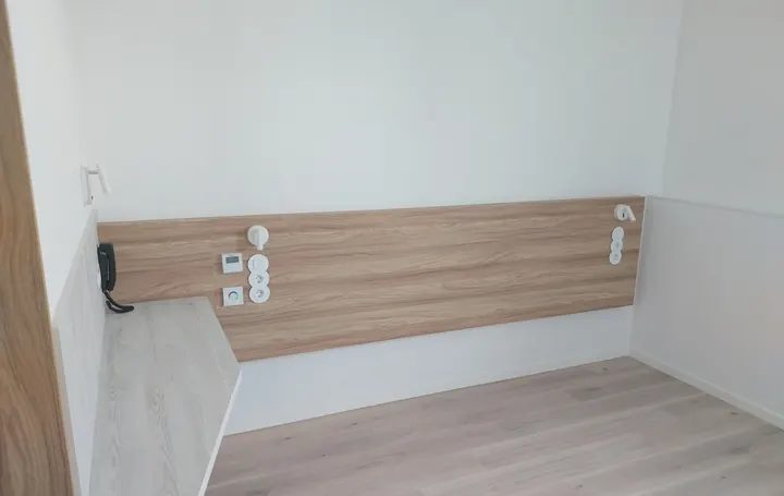 Quarto com cabeceira em madeira e pavimento flutuante